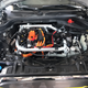 Under the hood and with the engine cover gone, you can see the electric motor and inverter.